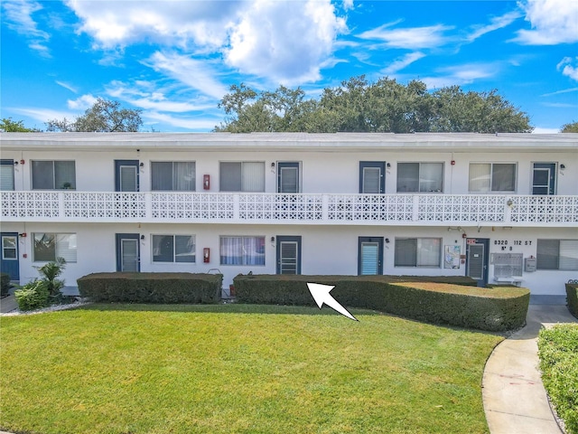 view of property featuring a front lawn