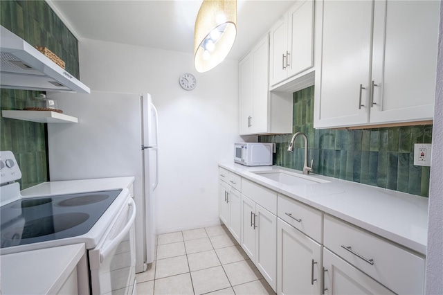 kitchen featuring white appliances, light tile patterned floors, white cabinetry, and sink