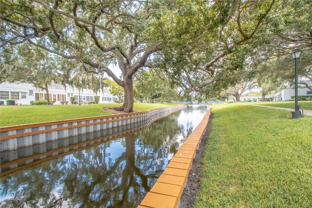 view of dock featuring a water view and a lawn