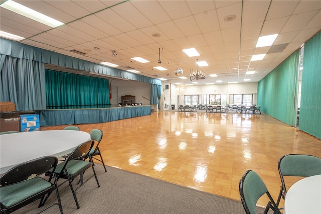 misc room with a paneled ceiling and a notable chandelier