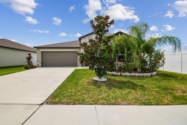 view of front of home with a garage and a front lawn