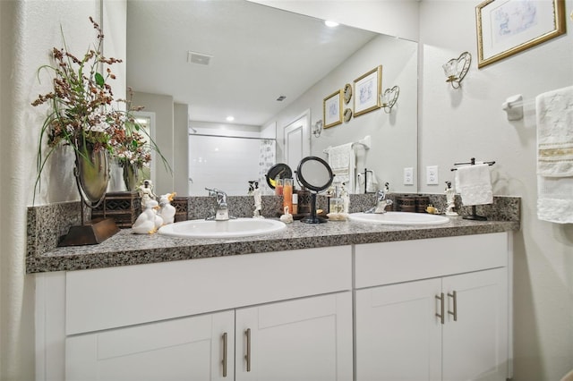 bathroom with vanity and an enclosed shower