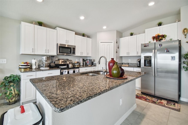 kitchen with a kitchen island with sink, appliances with stainless steel finishes, and white cabinetry