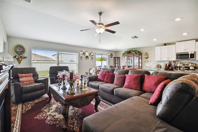 living room featuring a textured ceiling and ceiling fan