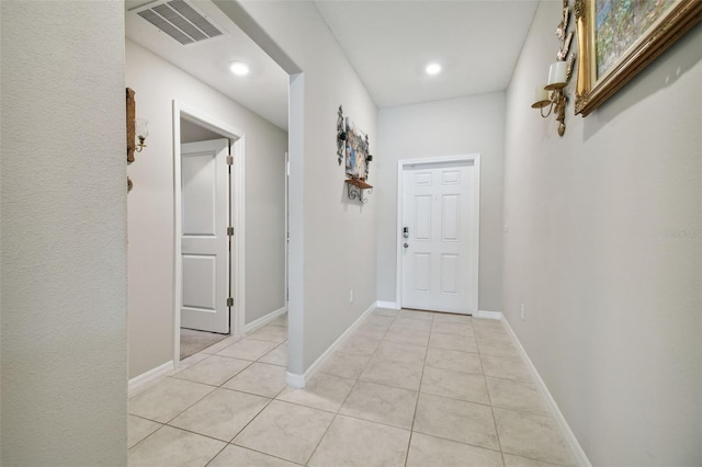 corridor featuring light tile patterned floors