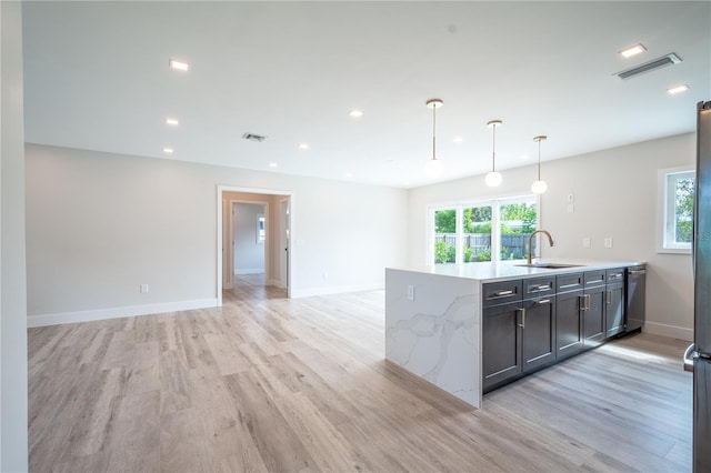 kitchen featuring pendant lighting, light hardwood / wood-style flooring, and a healthy amount of sunlight