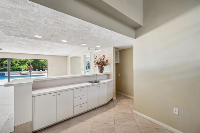 bathroom with vanity, tile patterned floors, and a textured ceiling