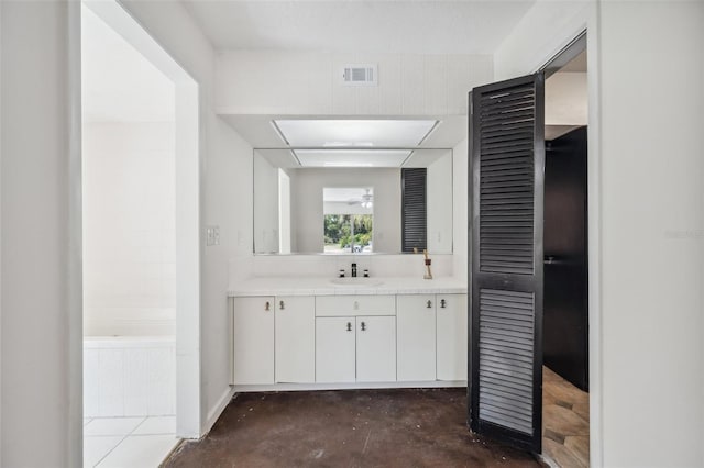 full bath with visible vents, a tub, unfinished concrete flooring, vanity, and a ceiling fan