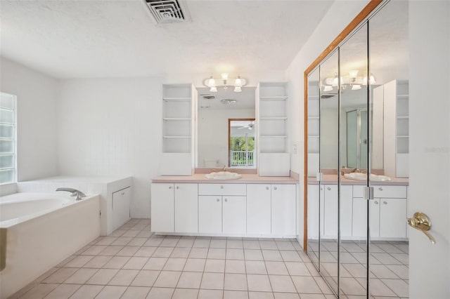 full bathroom with tile patterned floors, visible vents, two vanities, a sink, and a bath