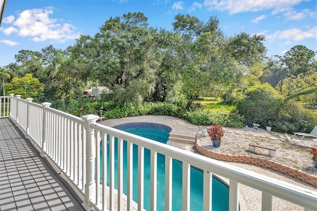 view of swimming pool with a hot tub