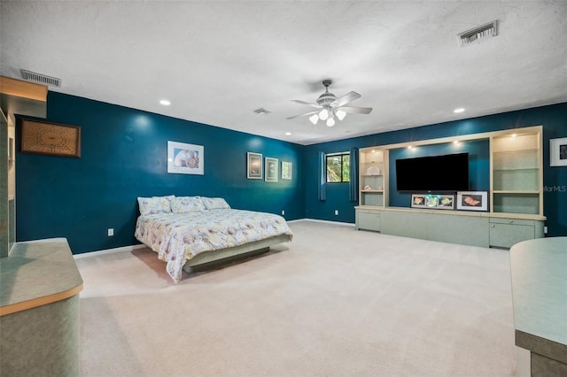 carpeted bedroom with a textured ceiling and ceiling fan