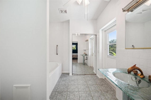 ensuite bathroom featuring a bathing tub, a shower, visible vents, and ensuite bathroom