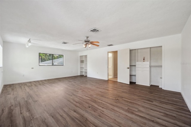 interior space with ceiling fan, a textured ceiling, and dark hardwood / wood-style flooring