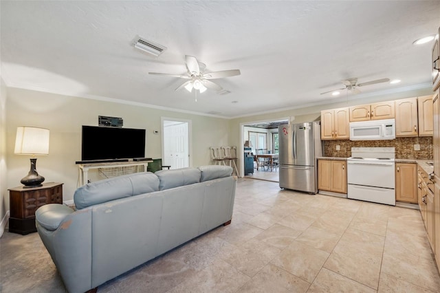 living room featuring crown molding, light tile patterned flooring, and ceiling fan