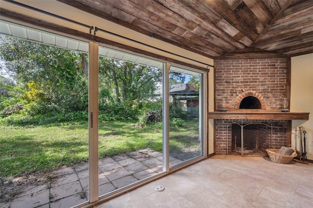 doorway featuring lofted ceiling, wooden ceiling, and a fireplace