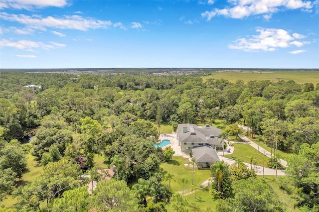 birds eye view of property with a view of trees