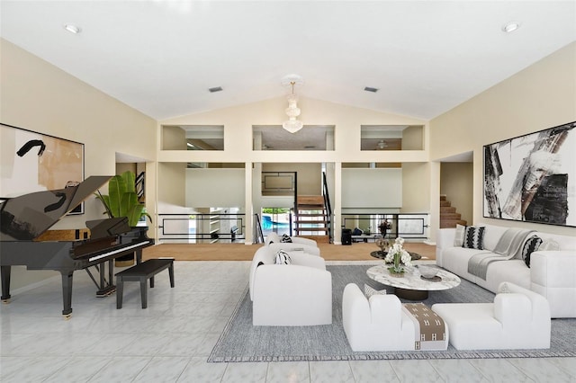 living room featuring stairway, high vaulted ceiling, and visible vents