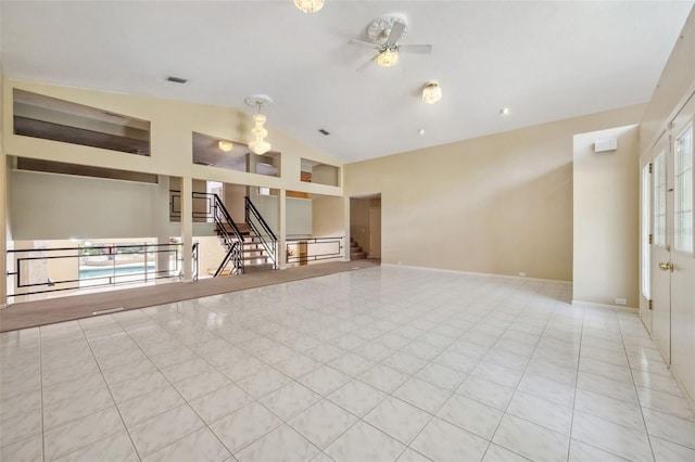 unfurnished living room featuring baseboards, visible vents, lofted ceiling, ceiling fan, and tile patterned floors