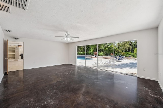 unfurnished room with baseboards, a ceiling fan, visible vents, and a textured ceiling