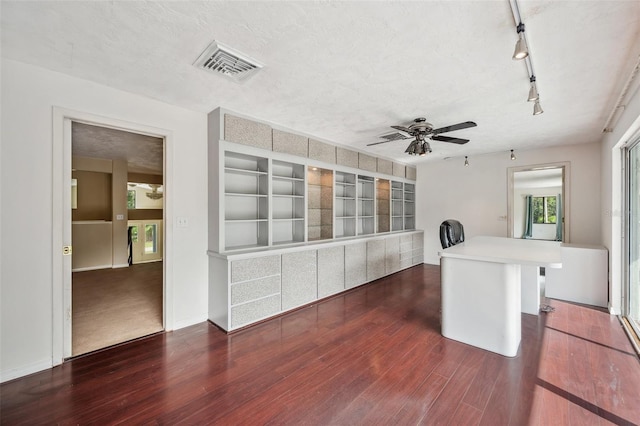 kitchen featuring a textured ceiling, kitchen peninsula, ceiling fan, track lighting, and dark hardwood / wood-style floors