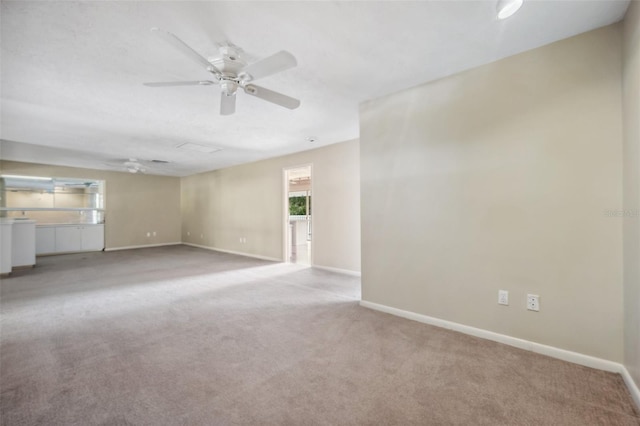 unfurnished living room featuring light carpet and ceiling fan