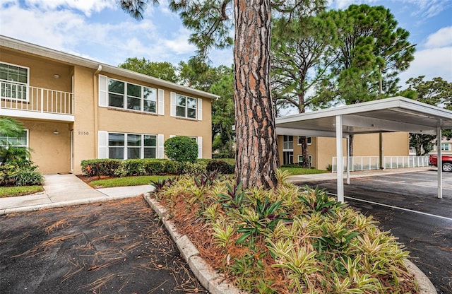 exterior space featuring a carport and a balcony