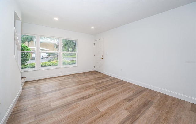 unfurnished room with light wood-type flooring