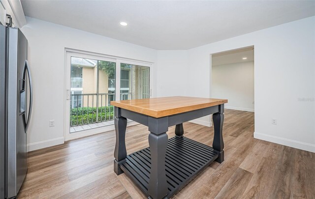 dining space with recessed lighting, baseboards, and wood finished floors