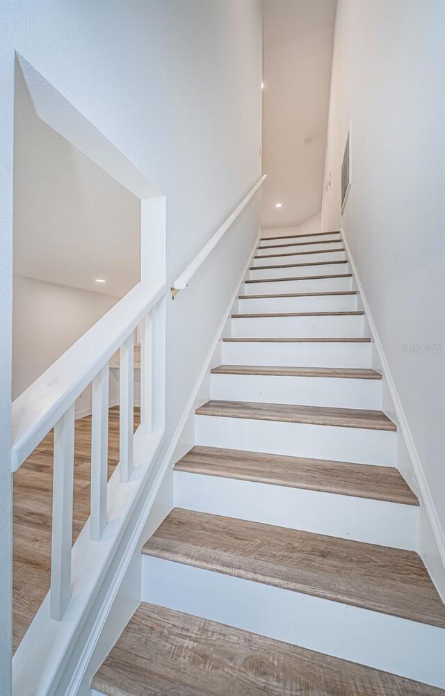 stairs featuring wood-type flooring