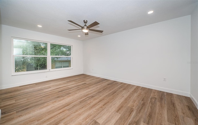 unfurnished room featuring recessed lighting, light wood-type flooring, and baseboards