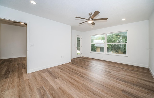 empty room featuring hardwood / wood-style floors and ceiling fan