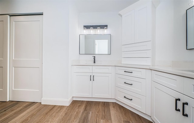 bathroom featuring vanity and hardwood / wood-style flooring