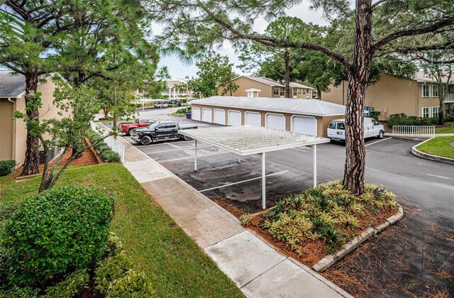 exterior space featuring a residential view and community garages