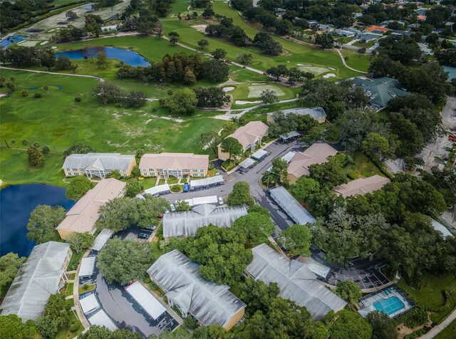 birds eye view of property featuring view of golf course, a water view, and a residential view