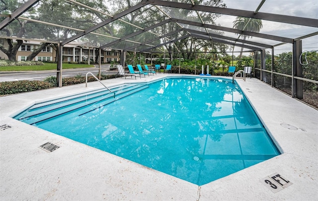 community pool featuring a lanai and a patio area