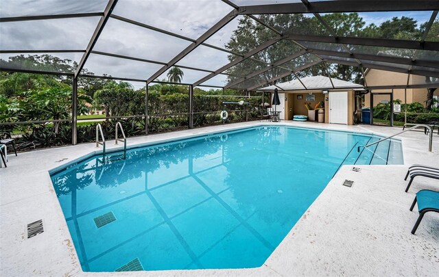 view of pool featuring a patio and glass enclosure