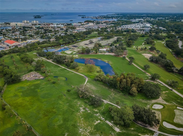 birds eye view of property featuring view of golf course and a water view