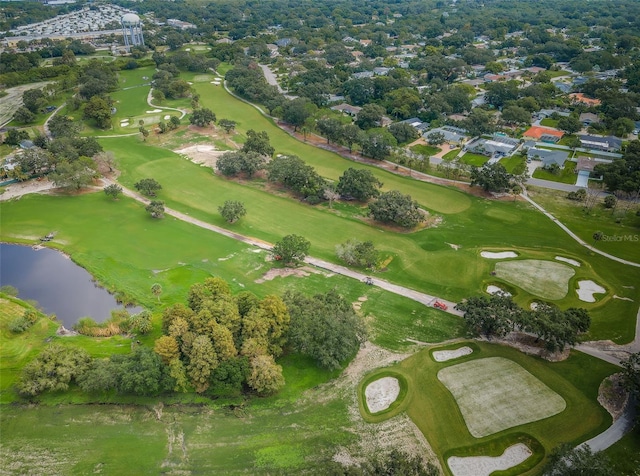 birds eye view of property with a water view and view of golf course