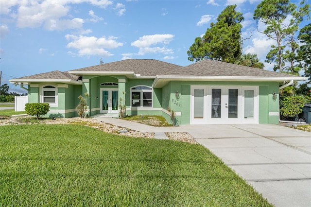 view of front of home with french doors and a front yard