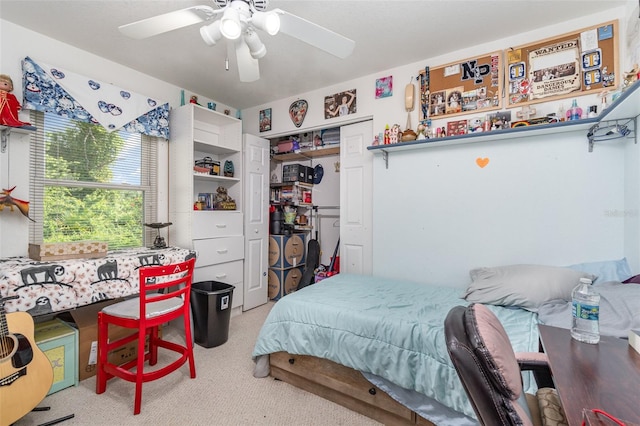 carpeted bedroom featuring a closet and ceiling fan