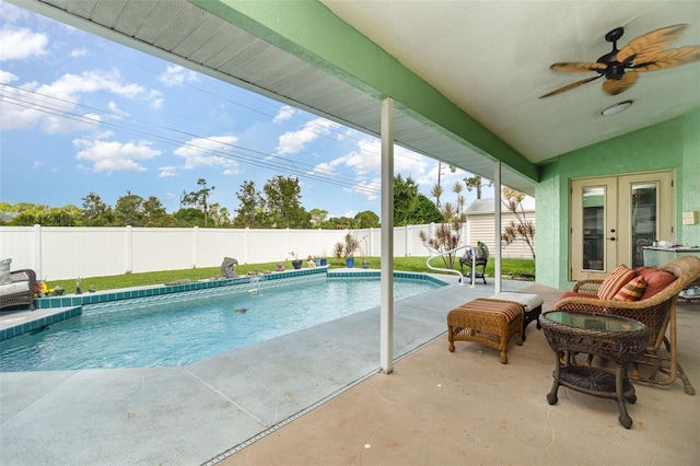 view of pool with ceiling fan, french doors, and a patio area