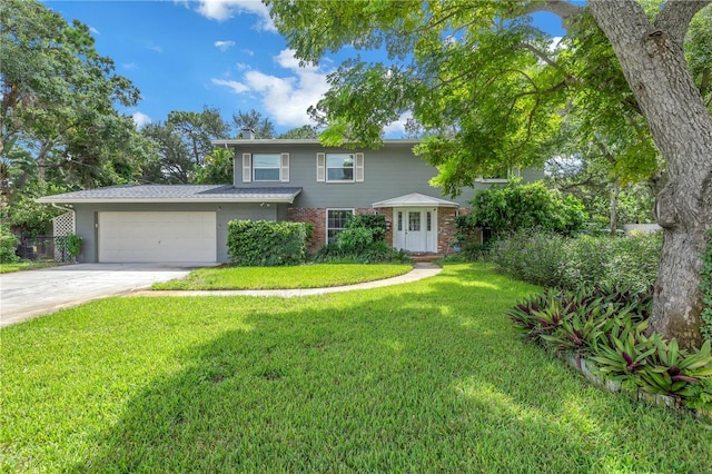 view of front of property with a garage and a front lawn