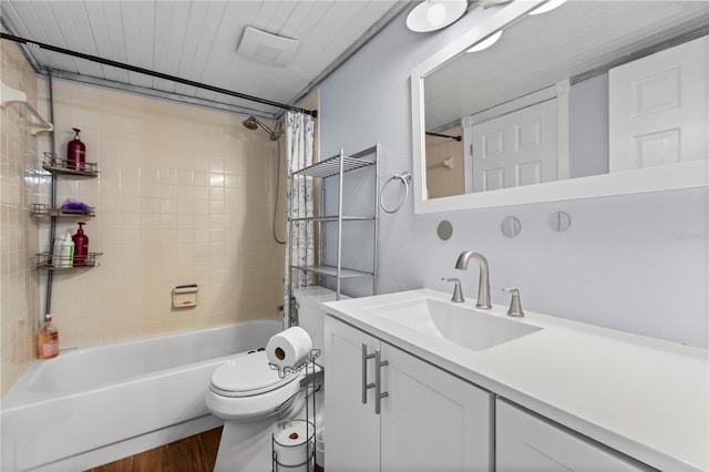 full bathroom with wood-type flooring, shower / bath combination with curtain, vanity, and toilet