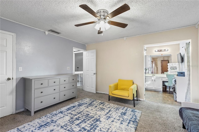 sitting room with a textured ceiling, ceiling fan, and carpet flooring