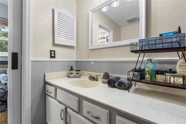 bathroom with vanity and a textured ceiling