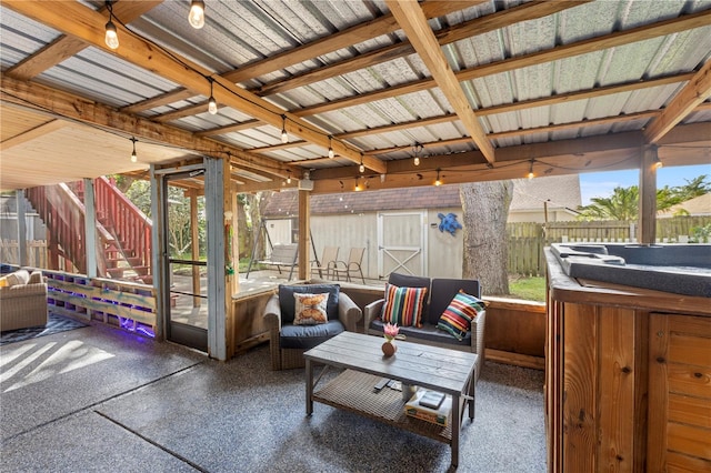 view of patio / terrace featuring a shed and a hot tub