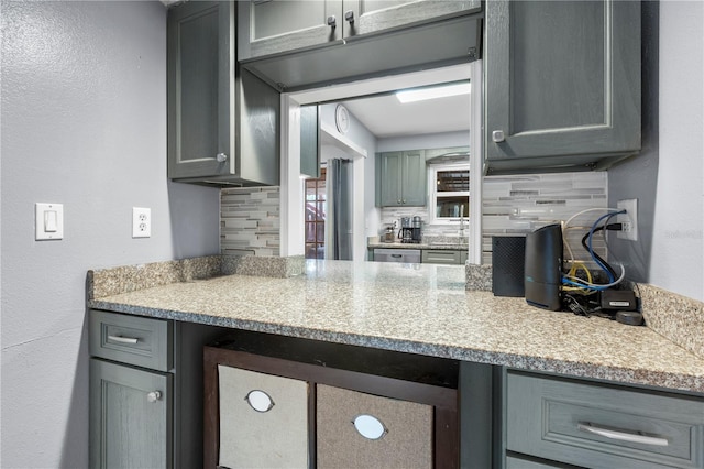 kitchen featuring gray cabinets and tasteful backsplash