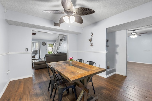 dining space featuring a textured ceiling, ceiling fan, and dark hardwood / wood-style flooring