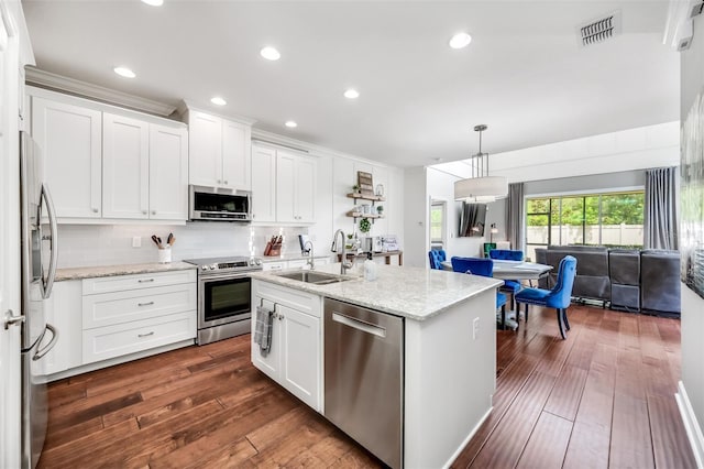 kitchen with white cabinets, light stone countertops, stainless steel appliances, sink, and dark hardwood / wood-style floors