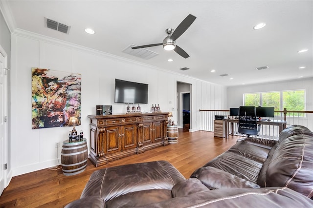 living room with ornamental molding, hardwood / wood-style floors, and ceiling fan